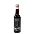 Flasche mit Haskap-Direktsaft aus Bio-Beeren, naturtrüb und tiefrot